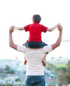 Father giving son piggyback ride outdoors