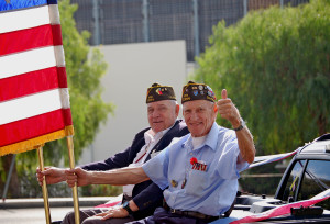 Military Veterans Holding Flags in Parade